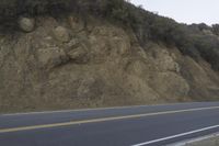 a street that has some rocks on it and the road is yellow and white, with a number of two points up to it