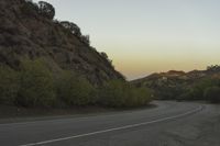 a street that has some rocks on it and the road is yellow and white, with a number of two points up to it