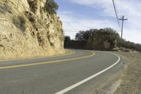 a street that has some rocks on it and the road is yellow and white, with a number of two points up to it