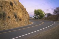a street that has some rocks on it and the road is yellow and white, with a number of two points up to it