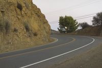 a street that has some rocks on it and the road is yellow and white, with a number of two points up to it