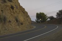 a street that has some rocks on it and the road is yellow and white, with a number of two points up to it