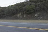a street that has some rocks on it and the road is yellow and white, with a number of two points up to it