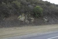 a street that has some rocks on it and the road is yellow and white, with a number of two points up to it