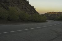 a street that has some rocks on it and the road is yellow and white, with a number of two points up to it