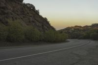 a street that has some rocks on it and the road is yellow and white, with a number of two points up to it