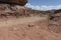 the dirt road leads through the barren terrain of the mountains at valley of fire state park