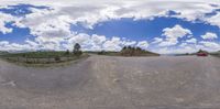 a fish eye lens image shows a car driving on the road with a fence in the background