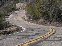 A Scenic Drive Through Low-Lying Mountains with Yellow Trees