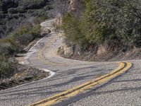 A Scenic Drive Through Low-Lying Mountains with Yellow Trees