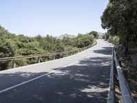 a truck is driving down the winding road at the top of the mountain of a hill