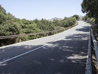 a truck is driving down the winding road at the top of the mountain of a hill