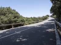 a truck is driving down the winding road at the top of the mountain of a hill