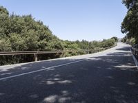 a truck is driving down the winding road at the top of the mountain of a hill