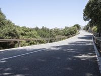 a truck is driving down the winding road at the top of the mountain of a hill