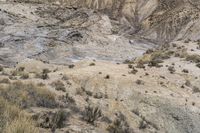 large rocks with rocks scattered on them and dirt ground around them to the top of a mountain