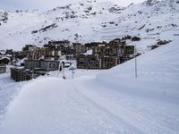 snow covered slope in the middle of a ski area as people ski on it near ski lift