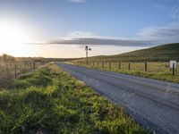 Scenic Highland Road: Surrounded by Mountains and Grass