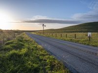 Scenic Highland Road: Surrounded by Mountains and Grass