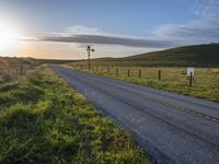 Scenic Highland Road: Surrounded by Mountains and Grass