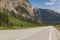 a mountain that has mountains on both sides and a highway in the middle of it