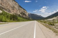 a mountain that has mountains on both sides and a highway in the middle of it