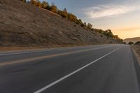 there is an image of a highway at sunset from the window of the vehicle driving down the road