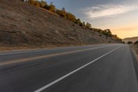 there is an image of a highway at sunset from the window of the vehicle driving down the road