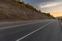 there is an image of a highway at sunset from the window of the vehicle driving down the road