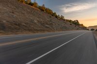 there is an image of a highway at sunset from the window of the vehicle driving down the road