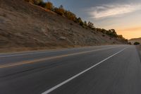 there is an image of a highway at sunset from the window of the vehicle driving down the road