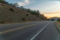 there is an image of a highway at sunset from the window of the vehicle driving down the road