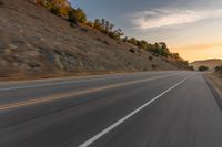 there is an image of a highway at sunset from the window of the vehicle driving down the road