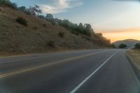 there is an image of a highway at sunset from the window of the vehicle driving down the road