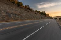 there is an image of a highway at sunset from the window of the vehicle driving down the road