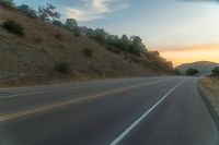 there is an image of a highway at sunset from the window of the vehicle driving down the road