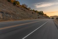 there is an image of a highway at sunset from the window of the vehicle driving down the road