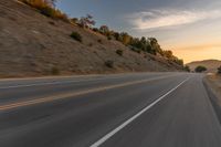 there is an image of a highway at sunset from the window of the vehicle driving down the road