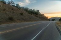 there is an image of a highway at sunset from the window of the vehicle driving down the road