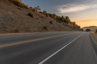 there is an image of a highway at sunset from the window of the vehicle driving down the road