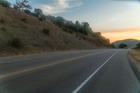 there is an image of a highway at sunset from the window of the vehicle driving down the road