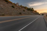 there is an image of a highway at sunset from the window of the vehicle driving down the road