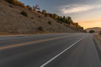 there is an image of a highway at sunset from the window of the vehicle driving down the road