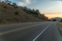 there is an image of a highway at sunset from the window of the vehicle driving down the road