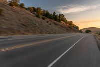 there is an image of a highway at sunset from the window of the vehicle driving down the road