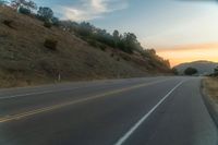 there is an image of a highway at sunset from the window of the vehicle driving down the road