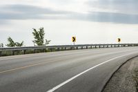 Scenic Highway with Yellow Lines and Clouds