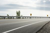 Scenic Highway with Yellow Lines and Clouds