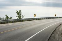 Scenic Highway with Yellow Lines and Clouds