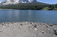 a lake that is surrounded by mountains on the edge of a mountain range in the background